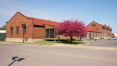 freight house exterior with blooming plum tree